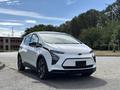 A 2023 Chevrolet Bolt EV parked with a sleek white exterior and modern design featuring distinctive headlights and a smooth curved shape