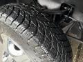 Close-up of a rugged tire featuring deep treads on a 2013 Chevrolet Silverado 3500HD showcasing its durability and traction