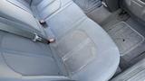 A gray fabric rear seat of a 2018 Hyundai Sonata with visible wear and a small stain on the left side of the seat