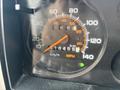 The dashboard of a 1994 GMC Vandura 3500 showing the speedometer with km/h and MPH markings and an indicator light