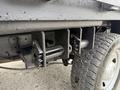 A close-up of the undercarriage of a 2015 Ford F-350 SD showcasing metal components and a textured surface along with part of a tire