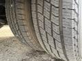 Close-up of a tire on a 2002 Ford Econoline showing tread pattern and wear