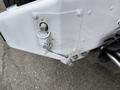 A white panel with a lever labeled ON and OFF and various bolts on a 2016 Peterbilt 348 truck's chassis