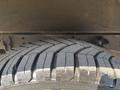 Close-up of a 2018 Ford Transit-350 tire showing detailed tread patterns and grooves designed for traction and stability