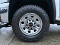 Close-up of a 2017 GMC Sierra 3500HD wheel featuring a shiny chrome rim and an aggressive all-terrain tire with the branding Geolandar on the sidewall