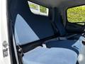Interior of a 2013 Mitsubishi Fuso FE160 featuring a blue fabric bench seat designed for multiple passengers