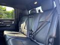 The interior of a 2018 RAM 3500 featuring black leather seats with seatbelts and a spacious back seat layout