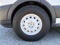 A close-up of a white wheel with a silver rim and black tire from a 2015 Ford Transit