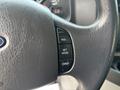 Close-up of the steering wheel of a 2013 Ford E-350 Super Duty featuring control buttons for cruise control including RES SET ACCEL and COAST
