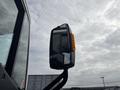 A side mirror of a 2020 Lion Lion6 vehicle showing reflective glass and an orange indicator light