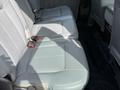 Interior view of a 2011 Ford F-350 SD showing the rear bench seat with light gray upholstery and seat belts