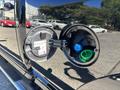 Close-up of the fuel cap on a 2015 RAM 1500 showing the fuel filler neck and nozzle with a green and blue cap inside