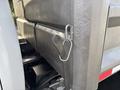 A close-up of a metal hook attached to the side of a 2013 RAM 5500 truck showcasing the sturdy construction of the vehicle's body and cargo area