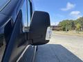Close-up of the side mirror of a 2025 Ford Transit T-350 showcasing the sleek design and integrated turn signal light