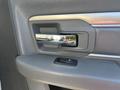 Close-up of the door handle and window controls on the interior of a 2014 RAM 5500 truck