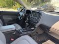 Interior view of a 2017 Chevrolet Colorado showcasing the dashboard center console gear shift and steering wheel with keys hanging from the ignition