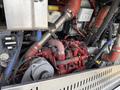 Close-up view of the engine compartment of a 2018 Grande West Vicinity featuring red and metallic pipes and various mechanical components