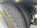 Close-up of two heavy-duty tires from a 2013 International WorkStar showing their tread patterns and surface details