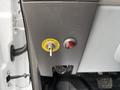 A cargo dome light switch with a yellow label and a red indicator button on a panel inside a 2019 Ford F-750