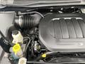 A close-up view of the engine compartment of a 2014 RAM Cargo Van showcasing the engine with various components like hoses and fluid reservoirs