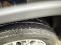 A close-up of a tire on a 2019 Jeep Grand Cherokee showing tread pattern and water splashes