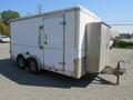 A white 2008 Wells Industries Inc EW1422 trailer with double axles and a side door featuring a diamond plate metal front