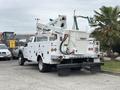 A 2018 Ford F-550 service truck with a white body and a Versalift aerial lift mounted on the back