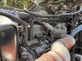 Close-up view of the engine components of a 2008 Kenworth T370 including hoses wires and a metal part with various connecting elements and tubes