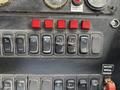 A control panel featuring various switches and buttons including lights wipers and additional functions for a 2012 International DuraStar 4300 vehicle