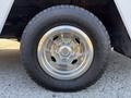 A close-up of a chrome wheel showcasing a shiny rim and an all-terrain tire labeled Open Country with deep treads