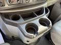 A center console with cup holders in a 2012 Ford Econoline E-450