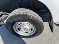 A close-up view of a tire on a 2016 Ford F-250 SD showing a silver rim and a rugged tire tread design