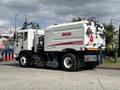 A 2012 Autocar Xpert street sweeper truck with a white and red body featuring an Elgin Crosswind label and a large front-mounted broom for cleaning streets