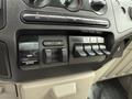 Control panel of a 2008 Ford F-450 SD featuring knobs for air conditioning and switches for various vehicle functions including gain output and lights