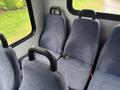 Interior seating of a 2018 Chevrolet Express featuring gray fabric seats with seatbelts positioned in a van layout
