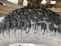 Close-up of a rugged tire tread from a 2005 Ford F-350 SD showcasing deep grooves and a sturdy design for off-road performance