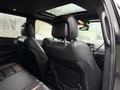 Interior view of a 2019 Jeep Grand Cherokee showing the backseat with black leather upholstery and headrests