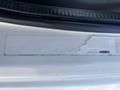 A 2014 Freightliner M2 106 vehicle identification number sticker partially faded with a white background and black text
