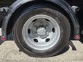 Close-up of a wheel on a 2016 Isuzu NPR-HD featuring a silver rim and black tire with the label Conti Hybrid HD
