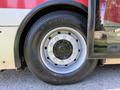 Close-up of a wheel from a 2016 Grande West Vicinity bus featuring a winter tire with a multi-bolt design and visible lug nuts