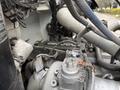 The image shows the engine compartment of a 2016 Peterbilt 348 with various metallic components including pipes and hoses interconnected around the engine block