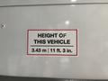 A height restriction sign on a 2020 Chevrolet Express indicating the vehicle's height as 3.43 meters or 11 feet 3 inches