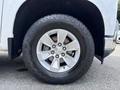 Close-up of a silver alloy wheel on a 2019 Chevrolet Silverado 1500 with a rugged tire tread visible on a black tire