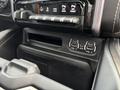 Interior console area of a 2021 RAM 1500 featuring control buttons for towing and two auxiliary ports