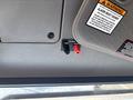 Close-up of a panel in a 2020 Peterbilt 330 featuring two connection ports labeled GND and 12VDC with red and black terminals