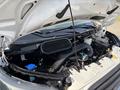 The engine compartment of a 2016 Ford Transit 150 showing the engine block various components and fluid reservoirs