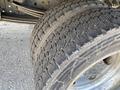 Close-up of a pair of worn tires from a 2014 Hino 195 showing visible tread patterns and cracks on the surface
