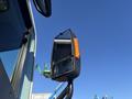 A side mirror of a 2022 Lion Lion6 with an orange LED light mounted on the edge