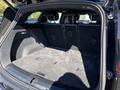 The interior of a 2023 Fisker Ocean showing the spacious cargo area with a flat floor and no rear seats in place