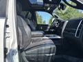 Interior view of a 2018 RAM 3500 showing front seats in black leather with a central console and dashboard controls